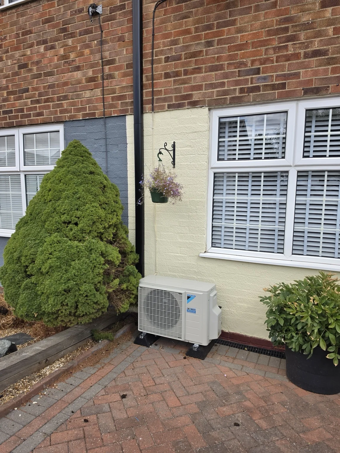 Daikin outdoor air conditioning unit beside a house